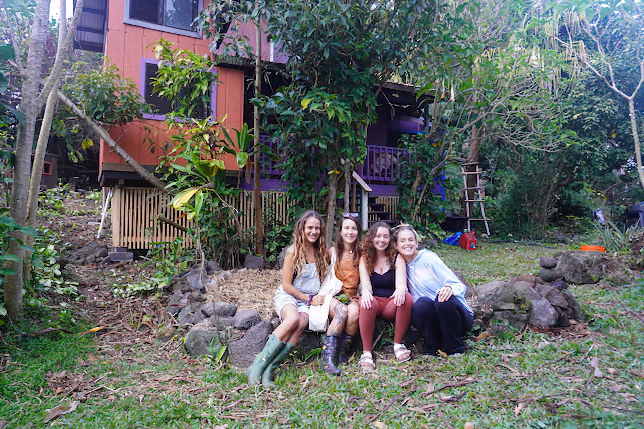 Women sitting on stone wall - Earthsong Foundation