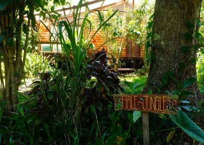 Hale Jungle exterior view with welcome sign - Earthsong Hawaii